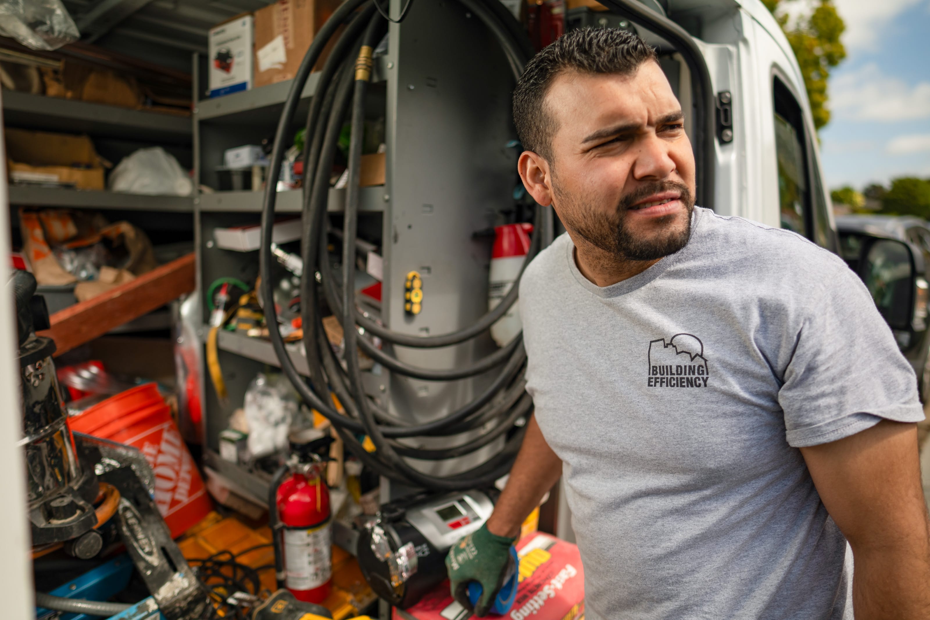 Contractor standing by a service van loaded with equipment